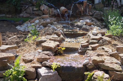 Click Here To Enlarge This Photo Of Creative stream and pond with wine bottles