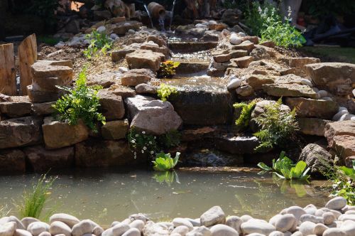 Click Here To Enlarge This Photo Of Creative stream and pond with wine bottles